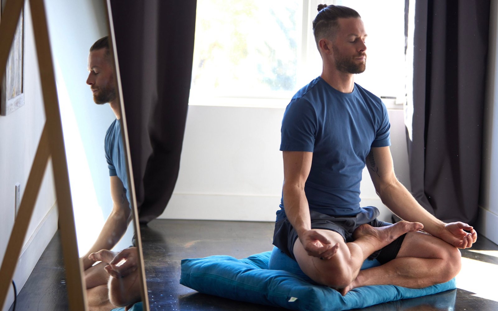 Man meditating on cushion